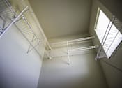 Thumbnail 13 of 21 - A white shelving unit is mounted on the wall.