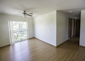 Thumbnail 16 of 21 - Empty room with a ceiling fan and sliding glass doors.
