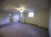 Thumbnail 16 of 22 - A room with a ceiling fan and two windows.