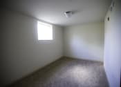 Thumbnail 13 of 22 - A room with a window and carpeted floor.