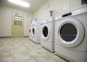 Thumbnail 11 of 22 - A row of washing machines in a laundromat.