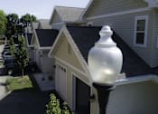 Thumbnail 7 of 22 - A white lamp post in front of a house.
