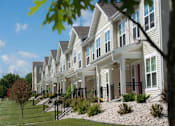 Thumbnail 2 of 22 - A row of houses with a tree in the foreground.