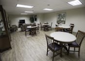 Thumbnail 1 of 22 - A room with a white table surrounded by chairs.