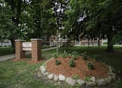 Thumbnail 20 of 27 - A sign that says Elementary School is in front of a building.