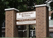 Thumbnail 21 of 27 - A brick pillar with a sign that says Elementary School.