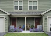 Thumbnail 24 of 27 - A house with a red door and a wreath on it.
