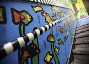 Thumbnail 9 of 27 - A mural of a flower and a striped pole.