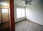 Thumbnail 11 of 13 - A room with a ceiling fan and a window.