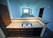 Thumbnail 8 of 13 - A kitchen with a sink and a window.