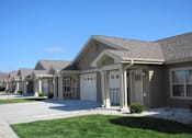Thumbnail 12 of 13 - A row of houses with a clear blue sky above them.