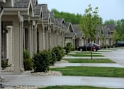 Thumbnail 2 of 13 - A row of houses with a tree in the front yard.