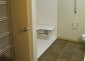 Thumbnail 14 of 18 - A bathroom with a toilet and a walk-in shower.