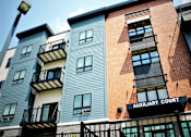 Thumbnail 2 of 18 - A tall building with a balcony and a sign that says Auxiliary Court.