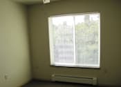 Thumbnail 10 of 18 - A room with a ceiling fan and a window with blinds.