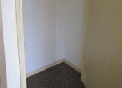 Thumbnail 18 of 18 - A white closet with a white shelf and a white door.