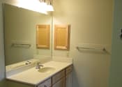 Thumbnail 16 of 18 - A bathroom with a sink and mirror.