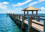 Thumbnail 4 of 4 - A wooden pier with a gazebo extends into the water.