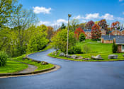 Thumbnail 4 of 4 - A curvy road with a lamp post on the side.