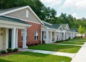 Thumbnail 7 of 11 - a row of houses with white pillars and green grass
