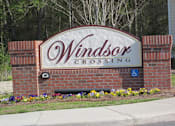 Thumbnail 4 of 11 - a sign for windsor crossing in front of a building