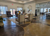 Thumbnail 8 of 15 - A living room with a circular floor and a fireplace.