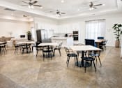 Thumbnail 6 of 8 - A spacious kitchen and dining area with a table set for six.