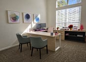 Thumbnail 8 of 8 - A room with a desk, chairs, and artwork on the wall.