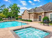 Thumbnail 1 of 8 - A swimming pool in front of a house.