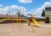 Thumbnail 5 of 7 - A playground with a yellow slide and climbing frame.