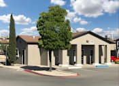 Thumbnail 7 of 7 - A building with a parking lot in front of it.