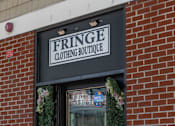 Thumbnail 21 of 25 - A storefront with a sign that says Fringe Clothing Boutique.