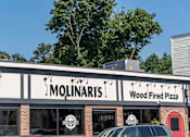 Thumbnail 24 of 25 - A Molinaris wood fired pizza restaurant with a car parked in front.