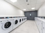 Thumbnail 18 of 23 - a washer and dryer laundry room with rows of washes and dryers