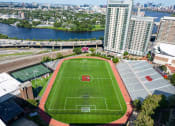 Thumbnail 23 of 23 - an aerial view of a soccer field in a city with a river