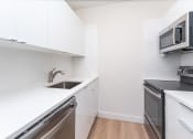 Thumbnail 12 of 23 - Babcock tower renovated apartment with vinyl wood flooring and stainless steel appliances