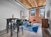 Thumbnail 10 of 18 - A room with a brick wall and a wooden ceiling.