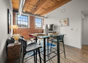 Thumbnail 8 of 18 - A dining room with a glass table and chairs.