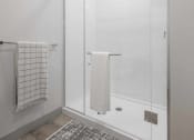 Thumbnail 24 of 25 - a bathroom with a shower and a towel rack