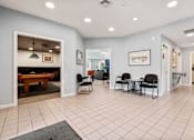 Thumbnail 23 of 39 - A spacious room with a pool table and chairs.