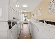 Thumbnail 26 of 39 - A laundromat with rows of washing machines.