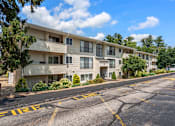 Thumbnail 37 of 39 - Apartment complex with a road in front of it.