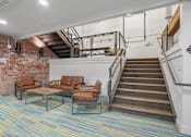 Thumbnail 19 of 29 - A staircase with a metal railing and a wooden handrail.