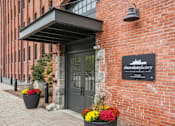 Thumbnail 23 of 29 - The entrance to a building with a sign that says Chocolate Factory Apartments.