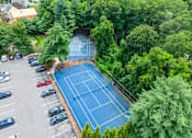 Thumbnail 10 of 28 - an aerial view of a tennis court and parking lot