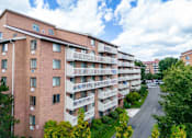 Thumbnail 2 of 28 - a view of an apartment building with a street in front of it