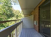 Thumbnail 21 of 28 - a balcony with a view of trees and a deck