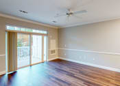 Thumbnail 16 of 26 - A room with a ceiling fan and sliding glass doors.