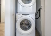 Thumbnail 7 of 25 - a washer and dryer stacked on top of each other in a laundry room