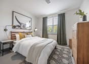 Thumbnail 4 of 25 - a bedroom with a bed and a dresser